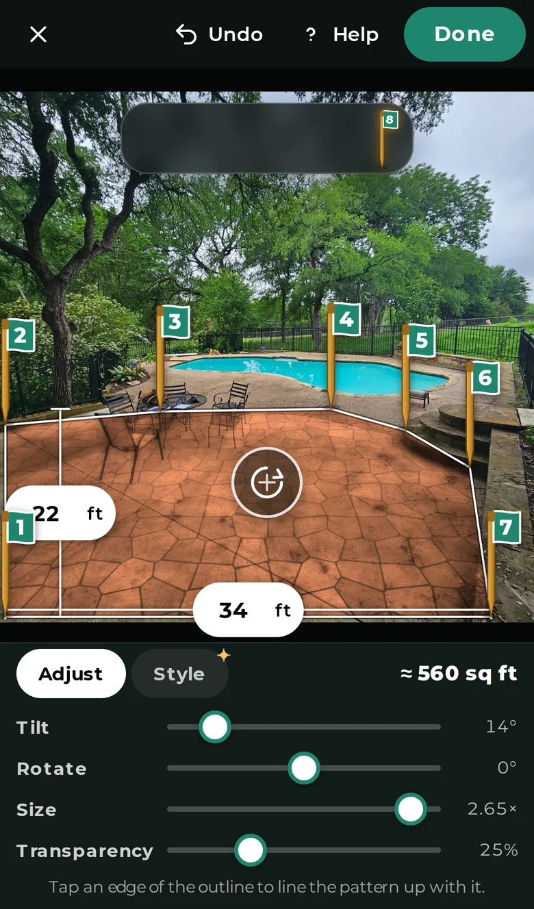 A pool deck photo with numbered stakes around the concrete, showing new flagstone across about 560 square feet
